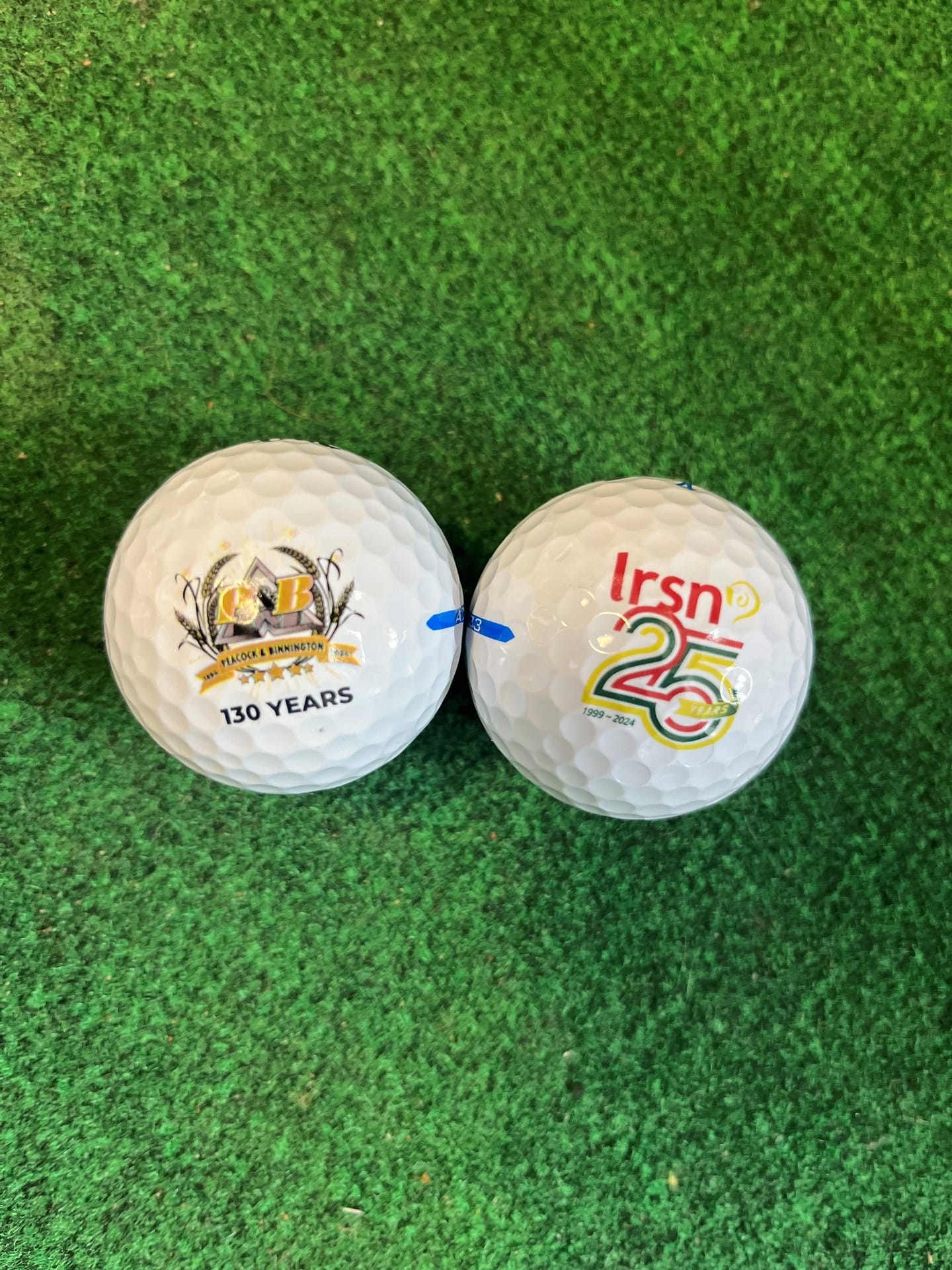 Two golf clubs on a green carpet